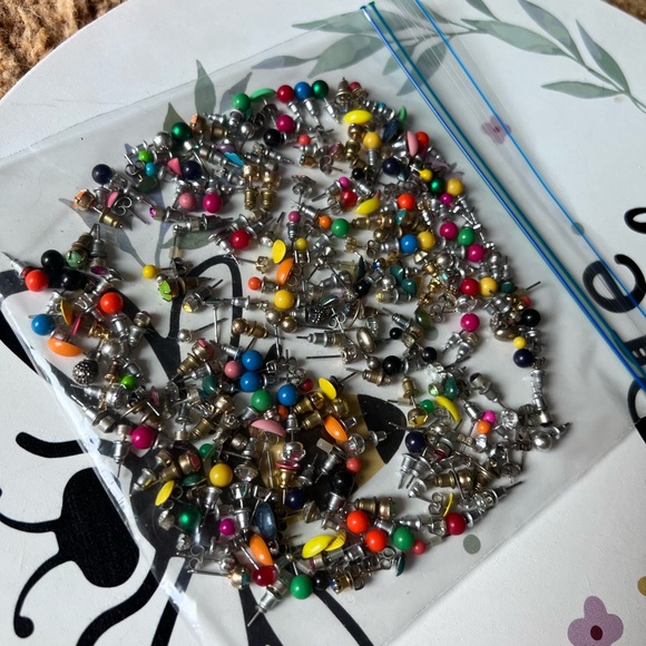 Bag full of different colored stud earrings. - Picture 5 of 13